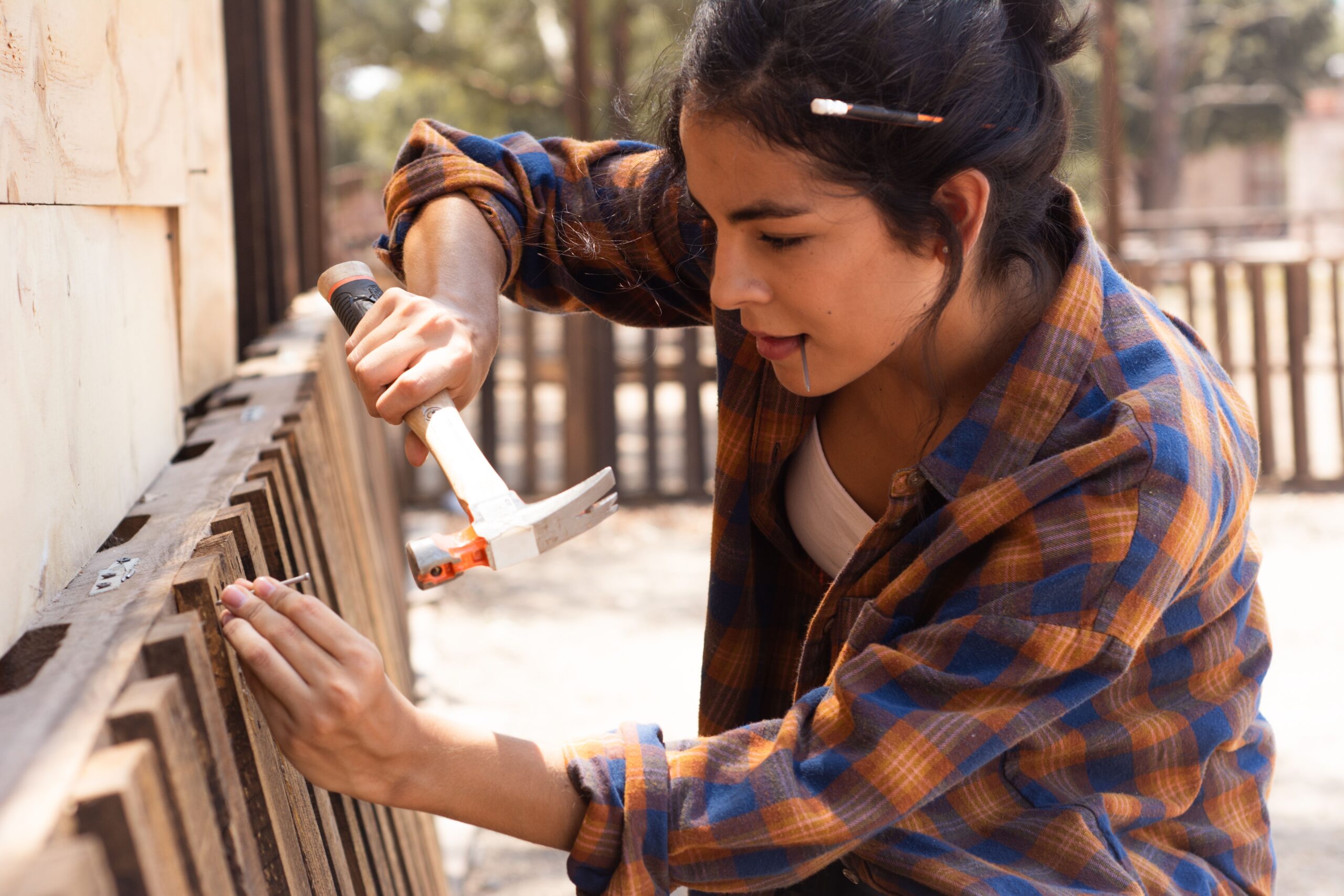 Technician performing fence repair and maintenance