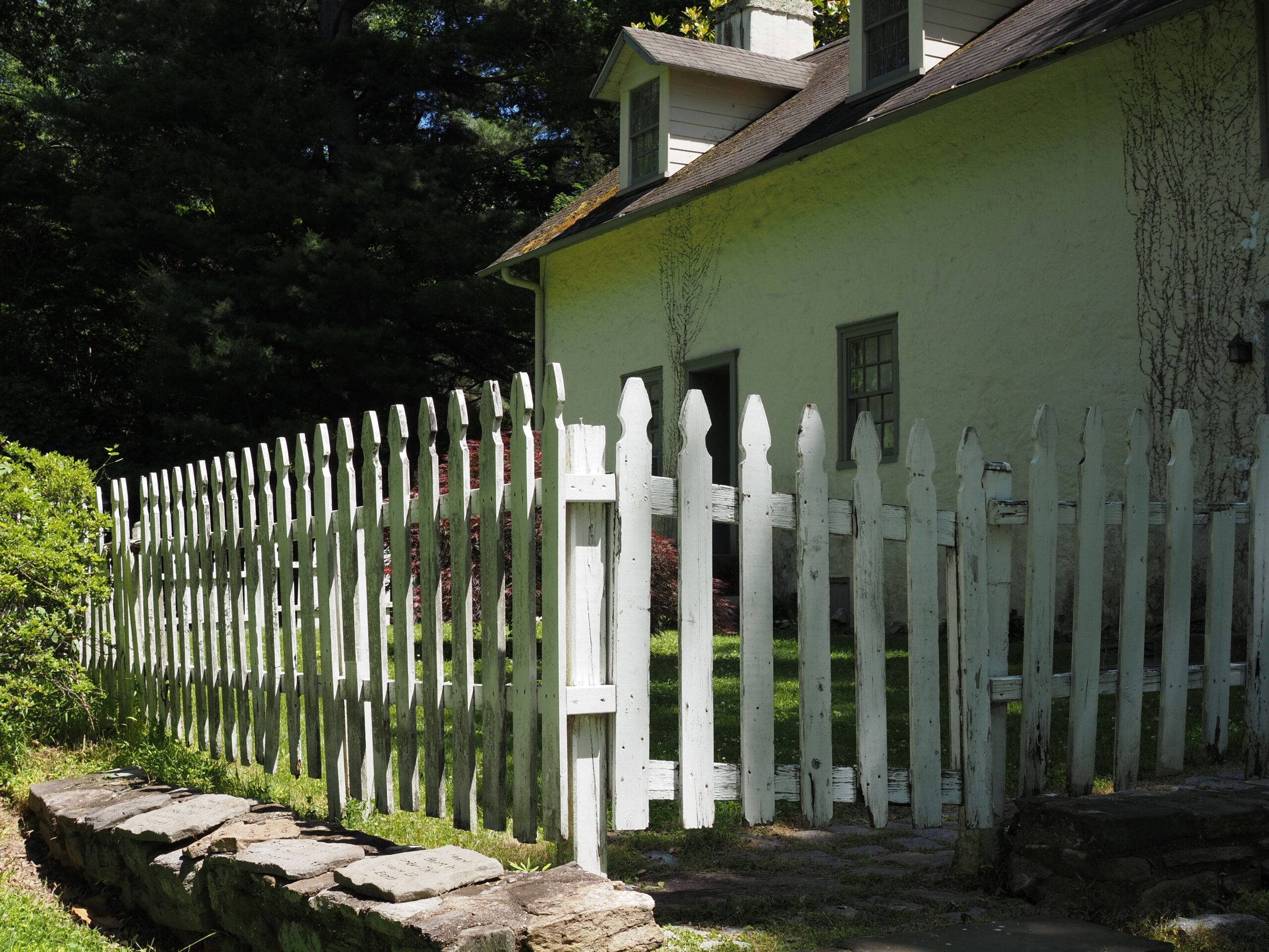 White picket fence surrounding a residential yard