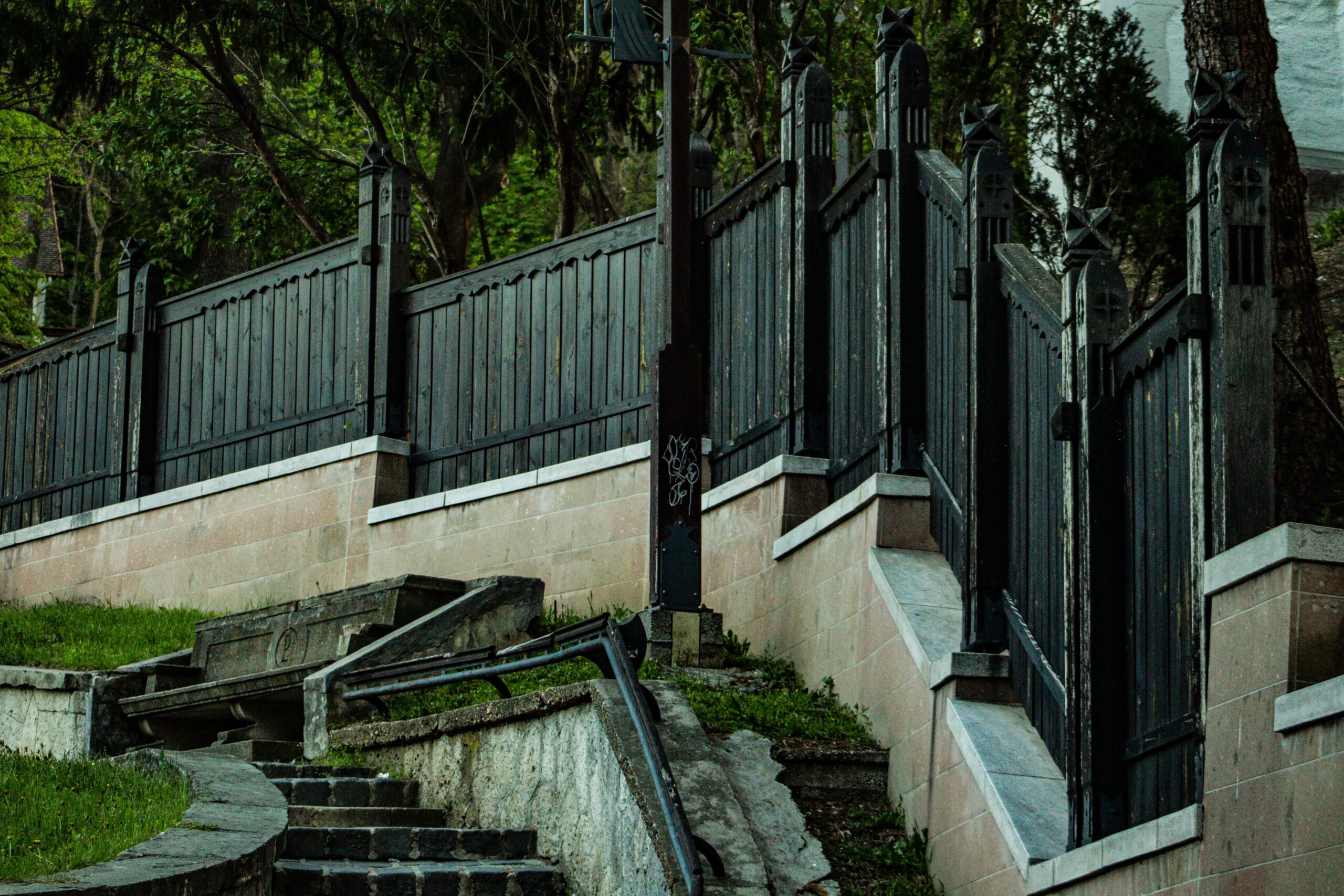 Black metal fence beside stairs