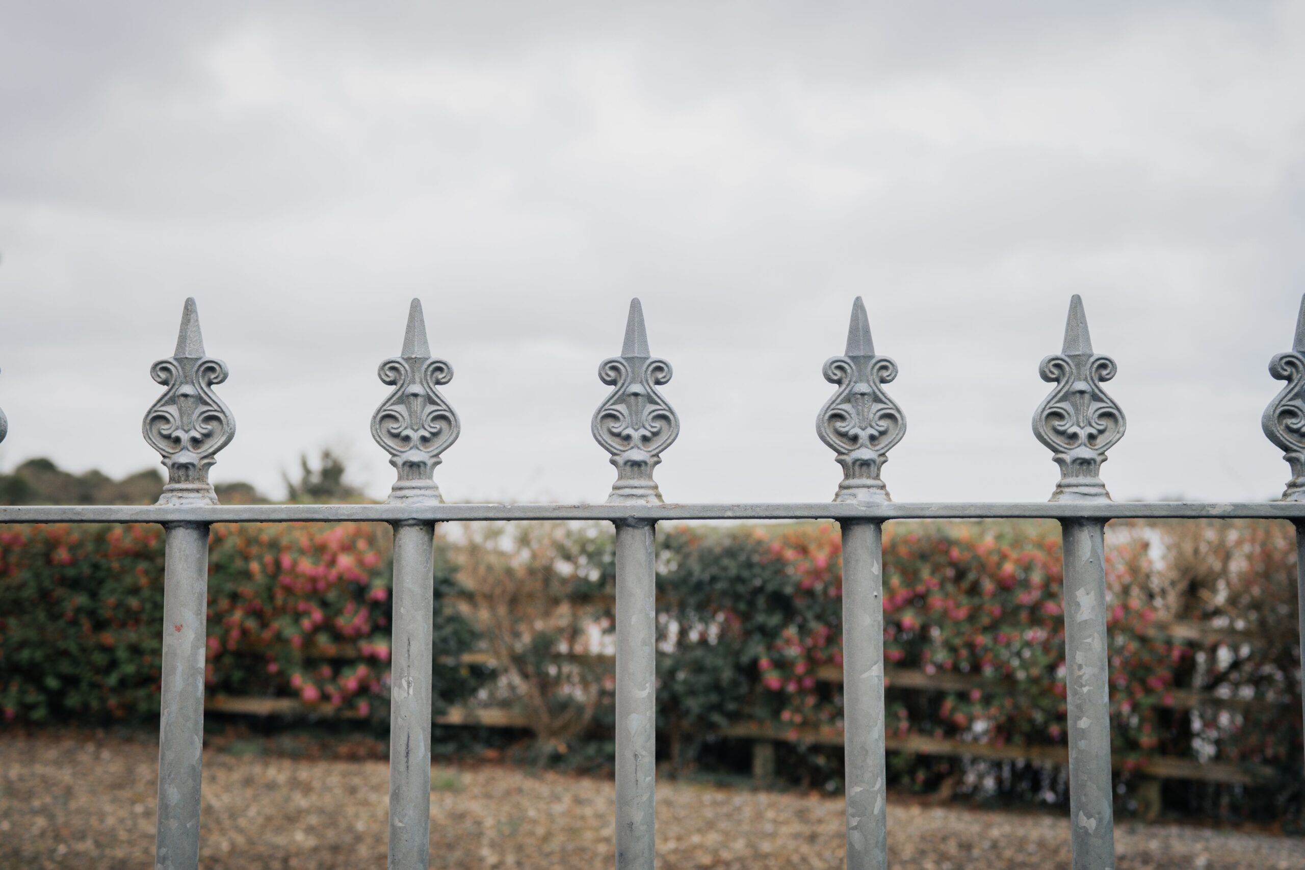 Decorative metal Custom fence surrounding a protected property