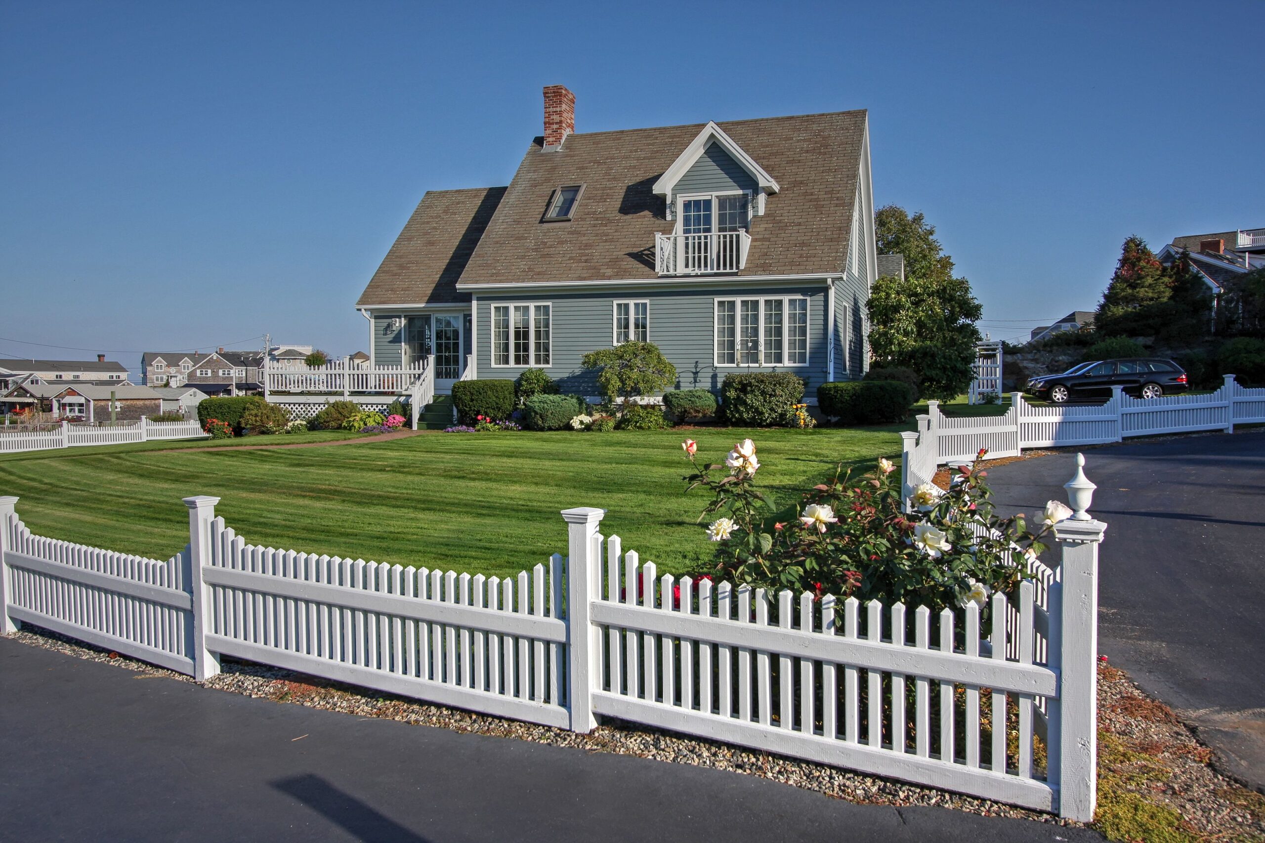 White vinyl fence around a residential home